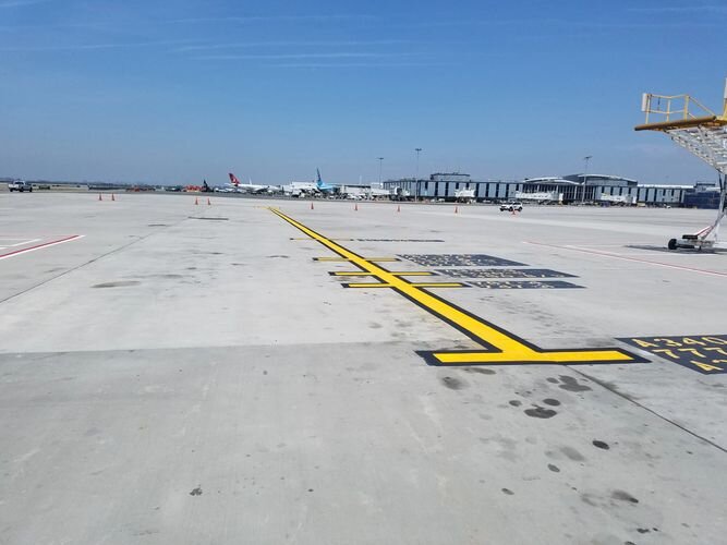 A runway with yellow lines painted on it.