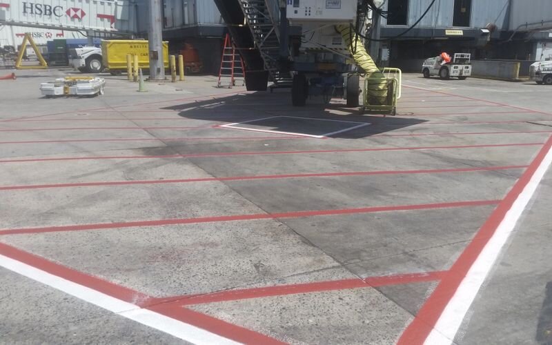 A truck parked in the middle of an airport runway.