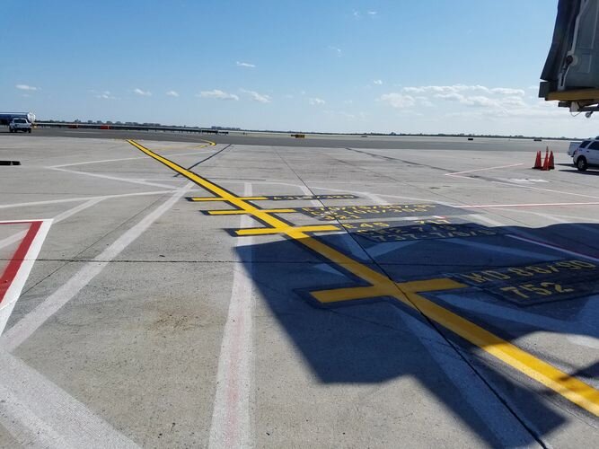 A yellow line is in the middle of an empty parking lot.