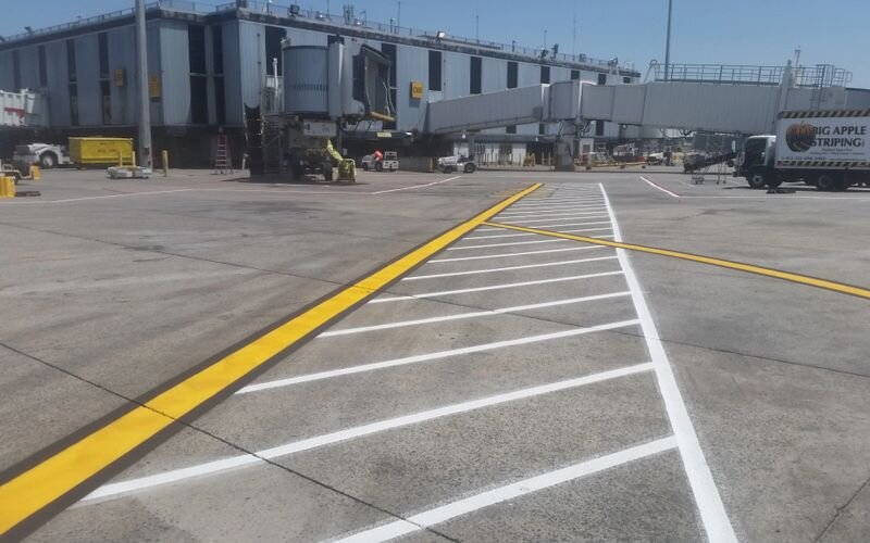 A parking lot with yellow lines painted on it.