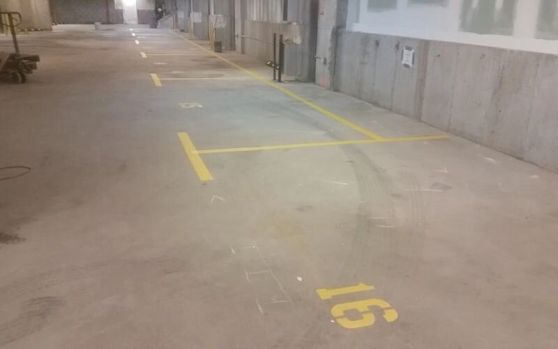 A parking lot with yellow lines painted on it.