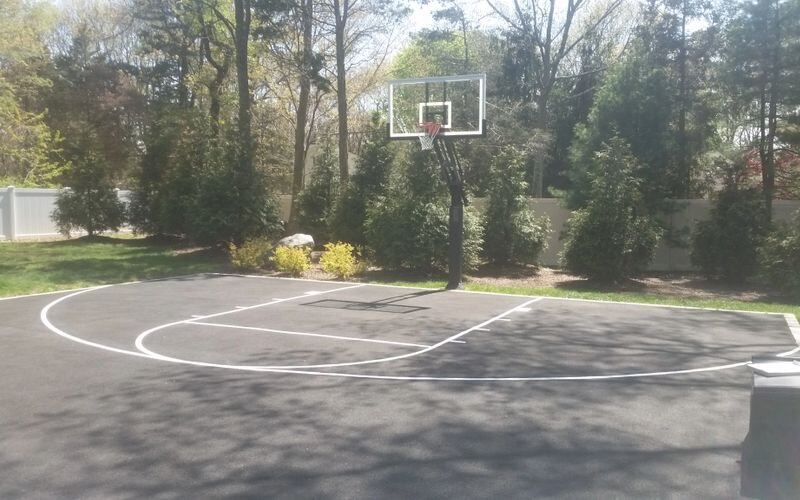 A basketball court with trees in the background