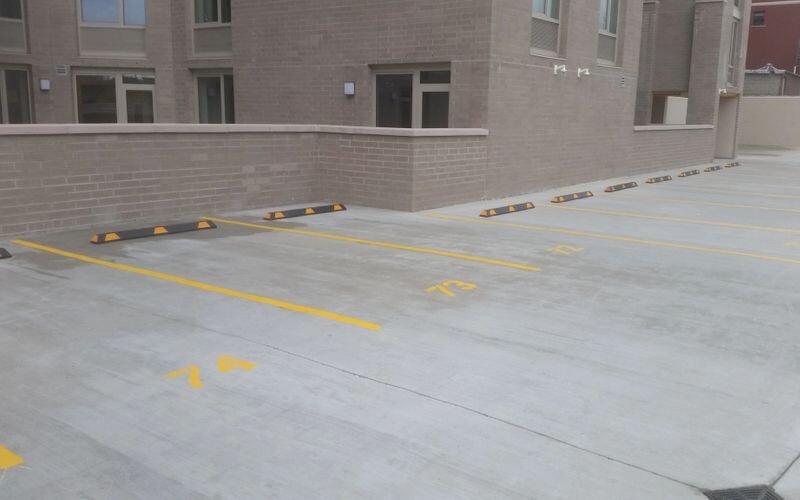 A parking lot with yellow lines painted on it.