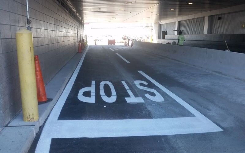 A parking garage with the word " stop " painted on it.