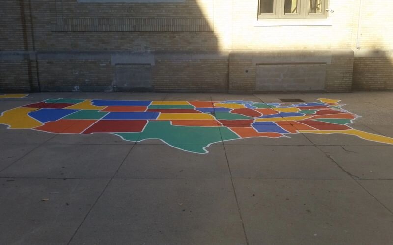 A colorful map of the united states painted on concrete.