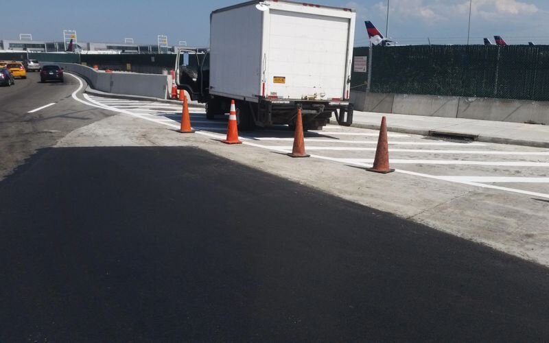 A truck is parked on the side of the road.