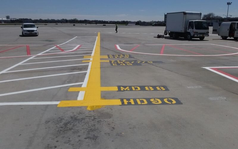 A man standing in an empty parking lot.