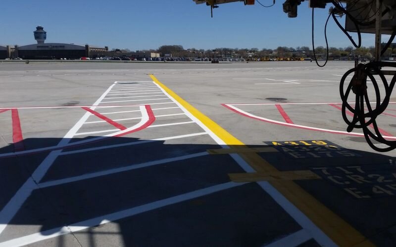 A view of an airport runway from the ground.