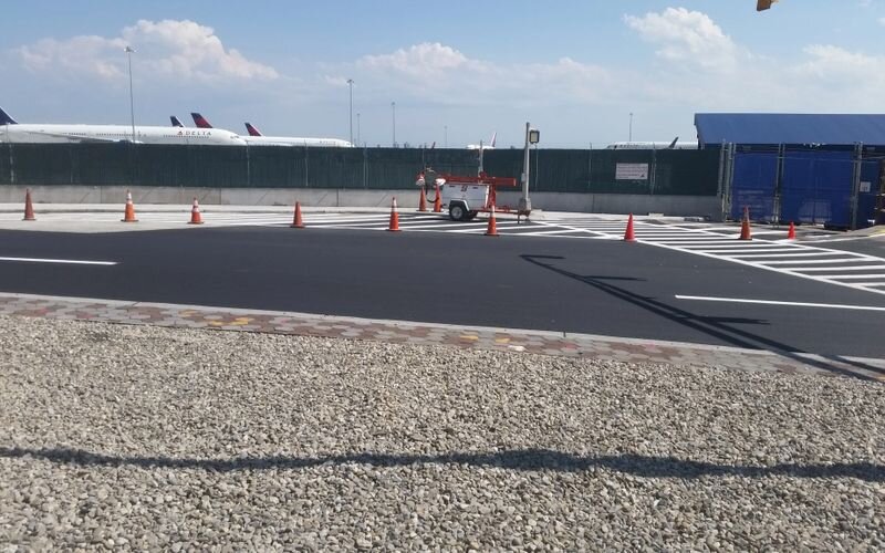 A person riding a motorcycle on top of an asphalt road.