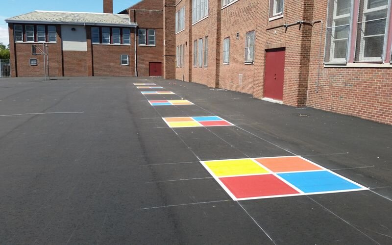 A parking lot with colorful squares painted on it.