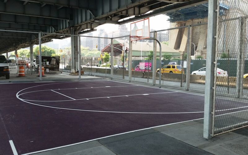 A basketball court with purple and white markings.