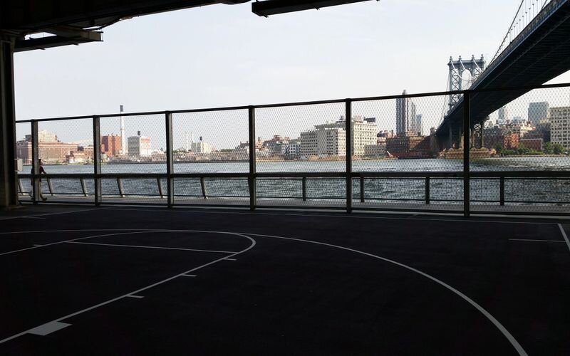 A basketball court with a view of the city.