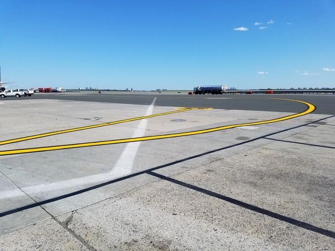 A view of an airport runway from the ground.