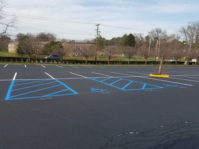 A parking lot with blue lines painted on it.