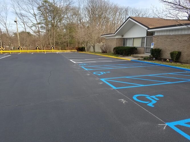 A parking lot with blue lines painted on it.