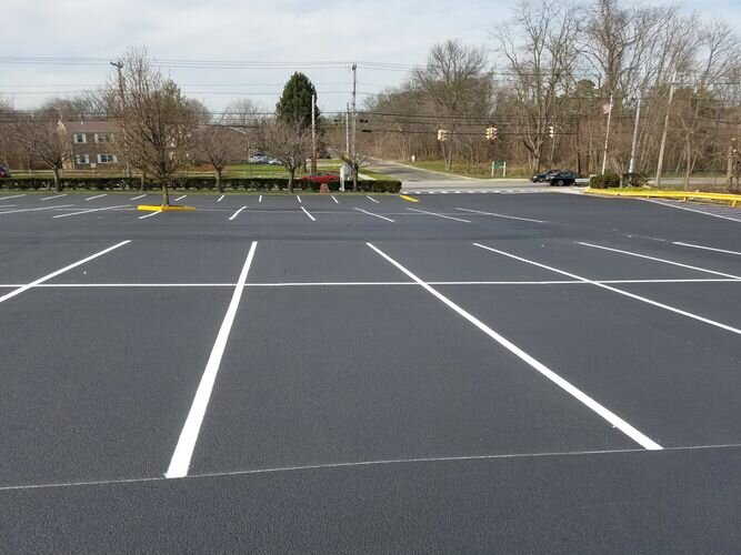 A parking lot with many lines painted white.