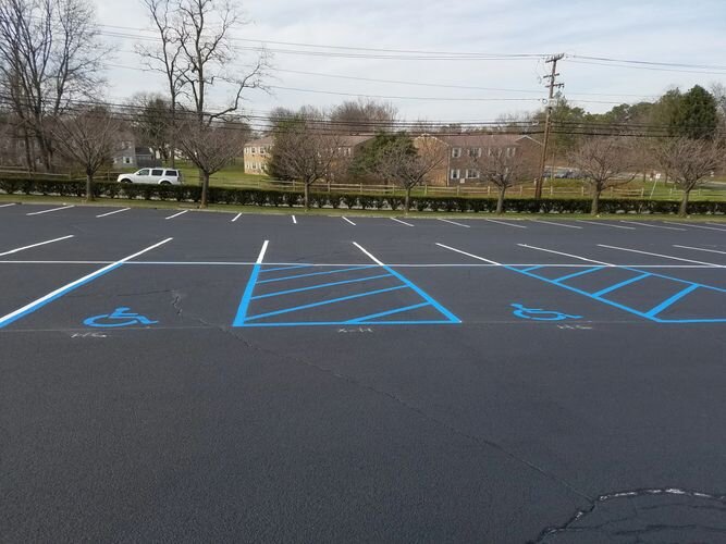 A parking lot with blue lines painted on it.