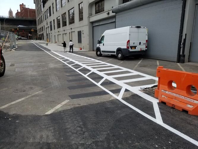 A white van parked in front of a building.