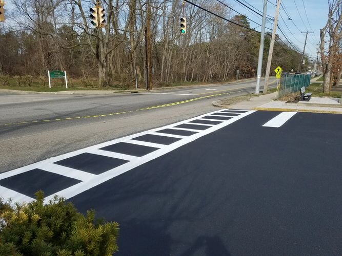 A street with a black and white stripe on the side.