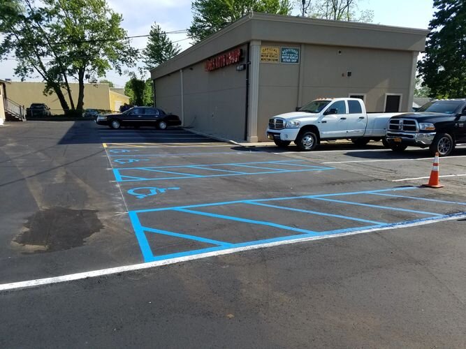 A truck parked in the middle of a parking lot.