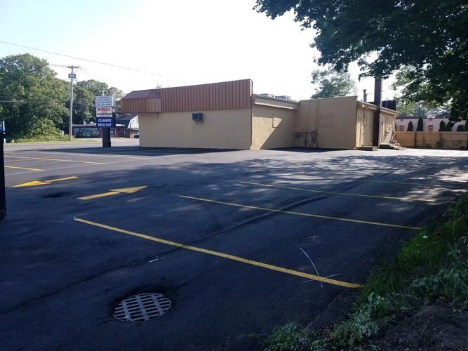 A parking lot with a building in the background.