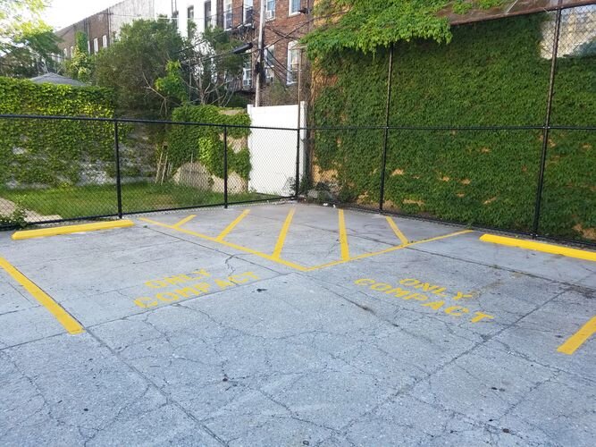 A parking lot with yellow lines painted on it.