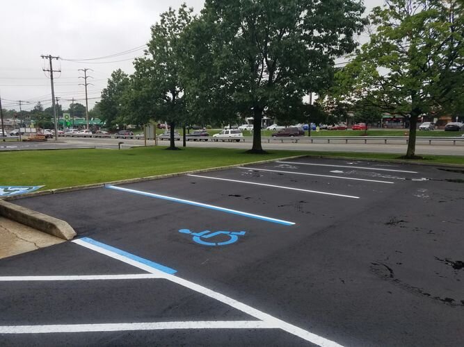 A parking lot with blue lines and a white line.