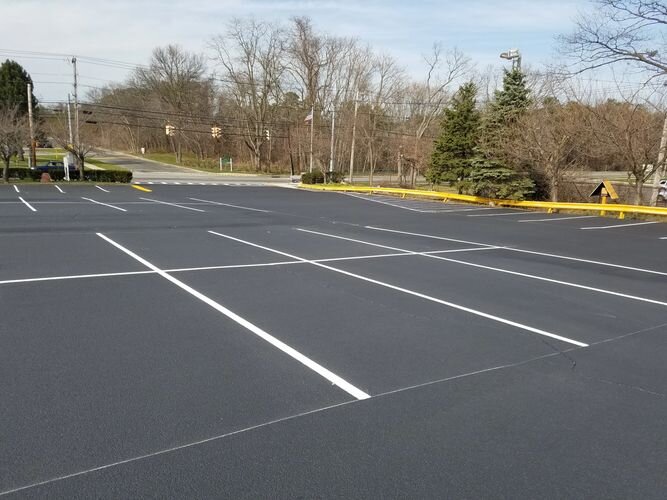 A parking lot with many lines painted white.