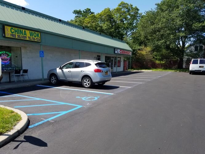 A car parked in the middle of a parking lot.