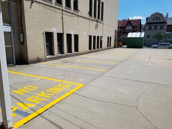 A parking lot with no parking written on it.