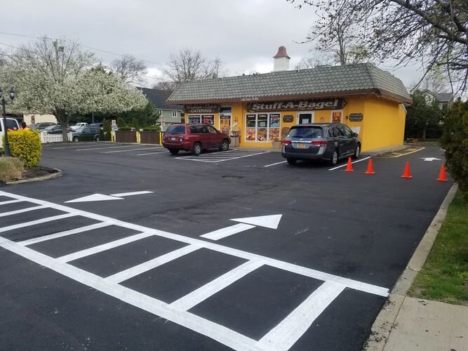 A parking lot with cars parked in front of it.