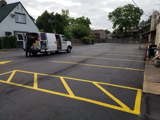 A van parked in the middle of a parking lot.