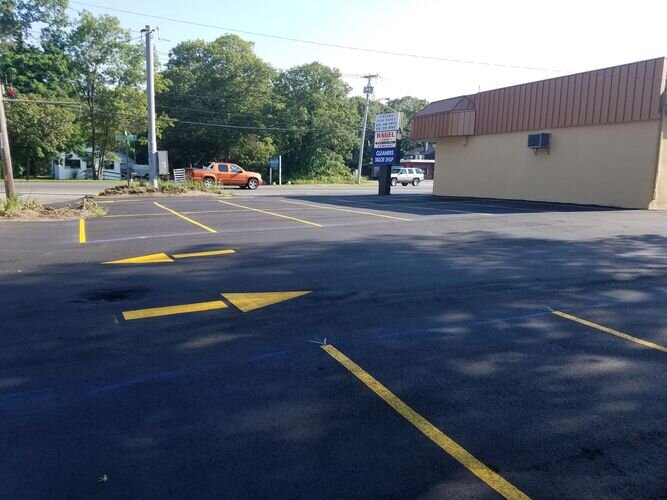 A parking lot with yellow lines on the side of it.