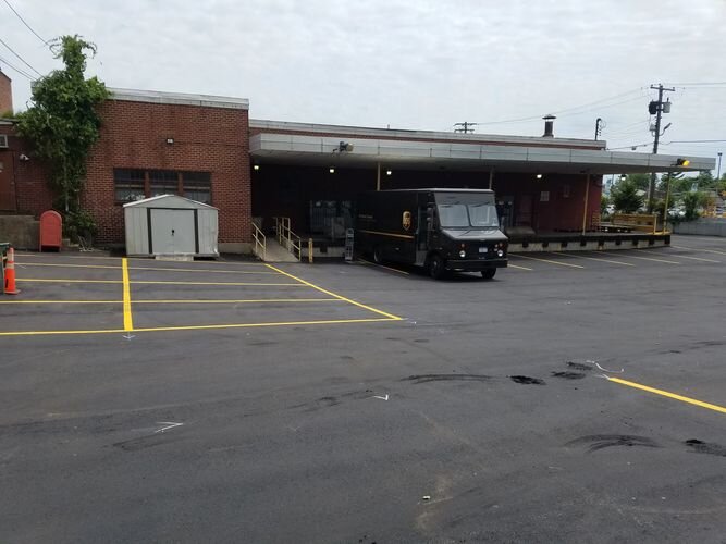 A van parked in the parking lot of a building.