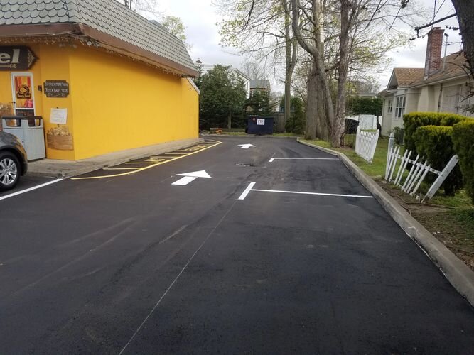 A street with no cars on it and yellow building