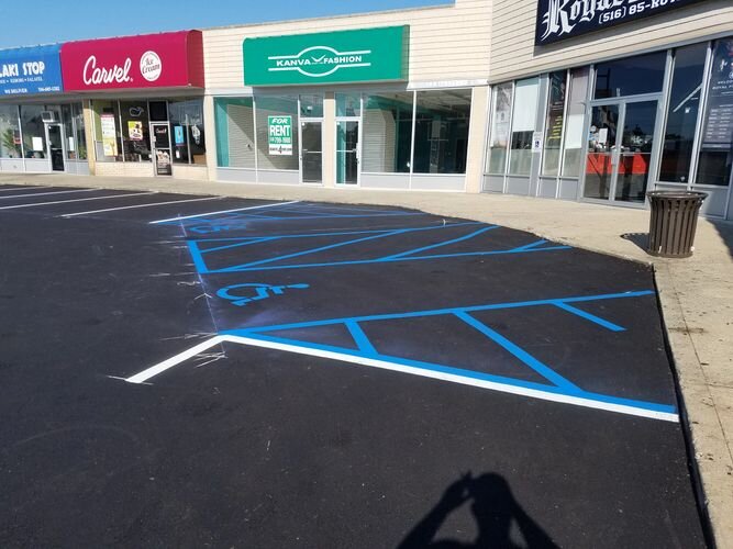 A parking lot with blue lines painted on it.