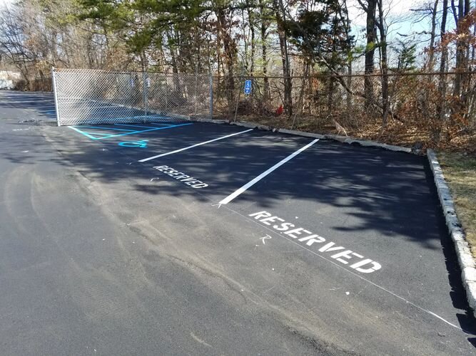 A parking lot with the word reserved painted on it.