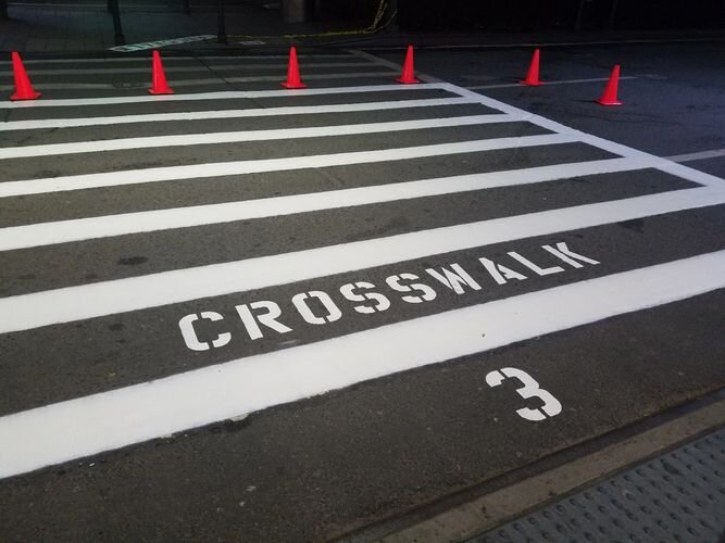 A crosswalk with the number 3 painted on it.