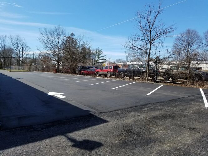 A parking lot with several cars parked in it.