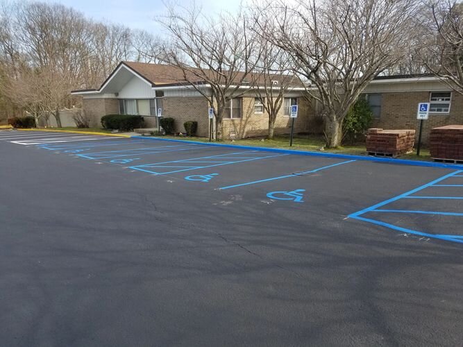 A parking lot with blue lines painted on it.