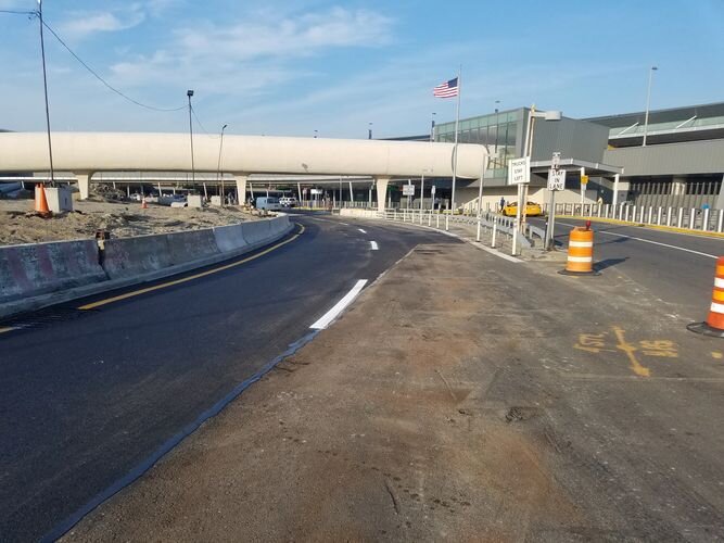 A road with no traffic and an empty parking lot.