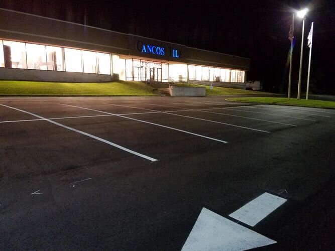 A parking lot with no one in it at night.