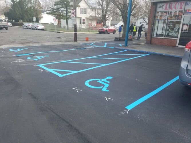 A parking lot with blue lines painted on it.