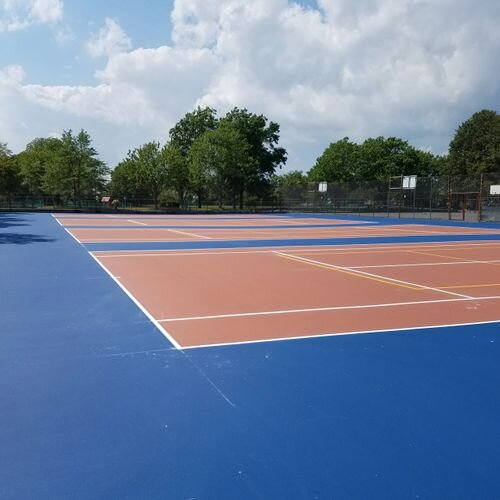 A tennis court with trees in the background.