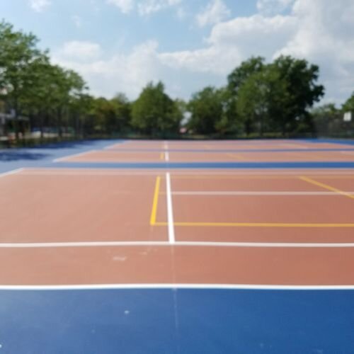 A tennis court with trees in the background.